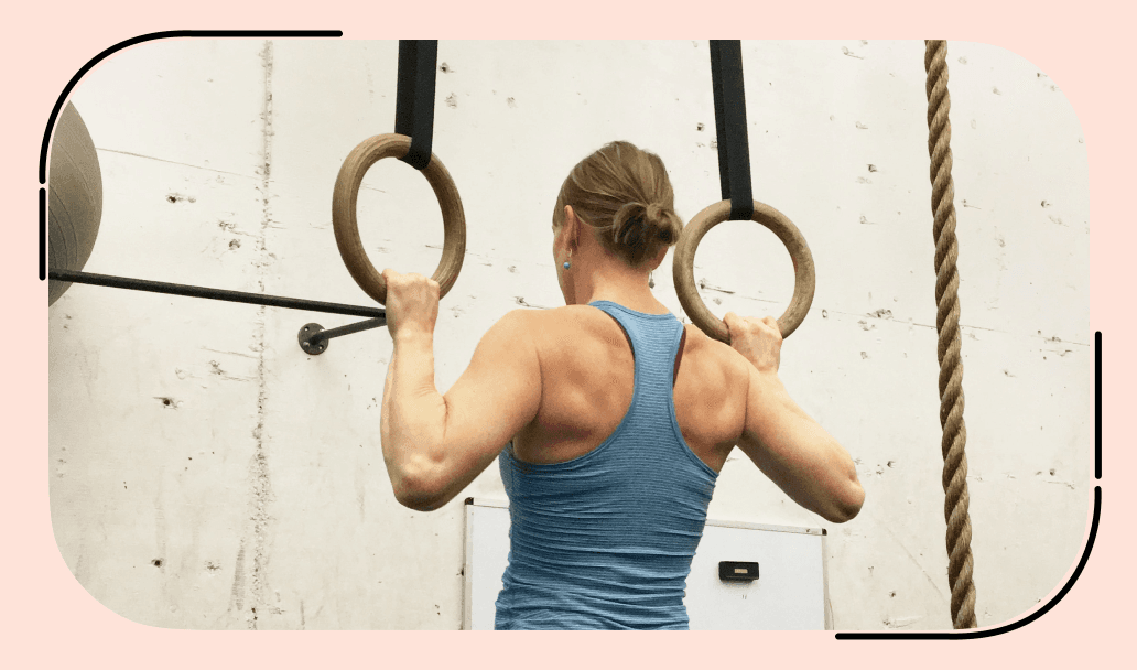 A girl successfully perform ring pull-ups