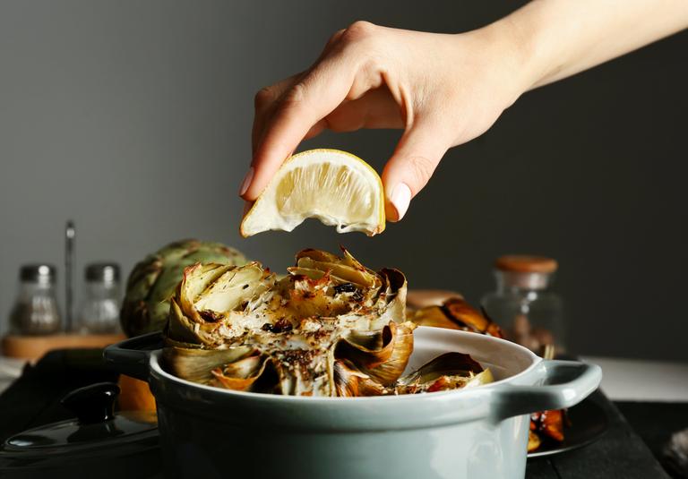 Take artichokes out of the oven. Sprinkle them with lemon juice